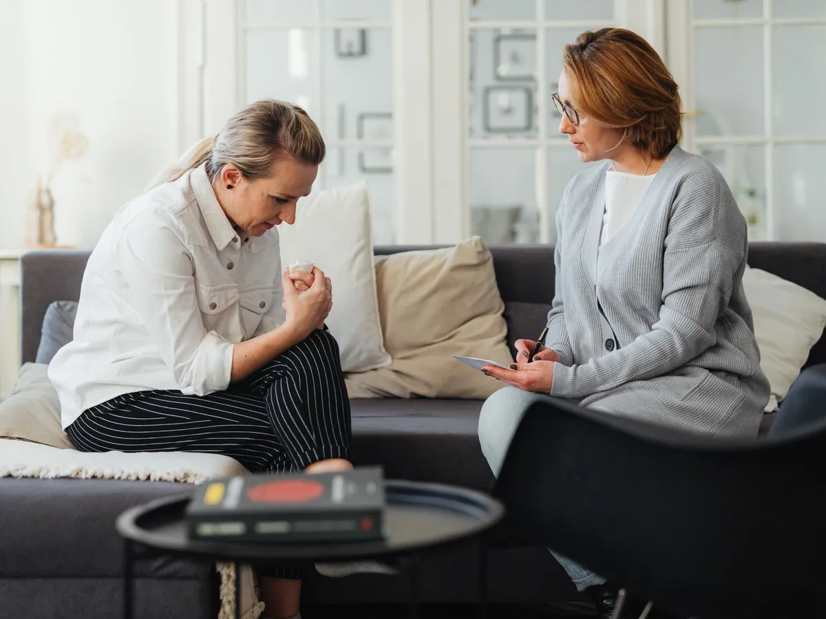 A therapist and client in a counseling session, capturing feelings and support.