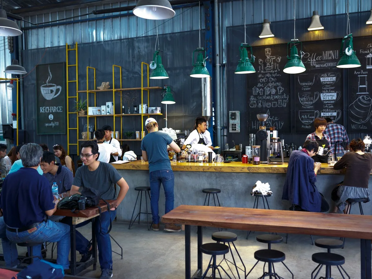 Customers gather inside a café and bar.