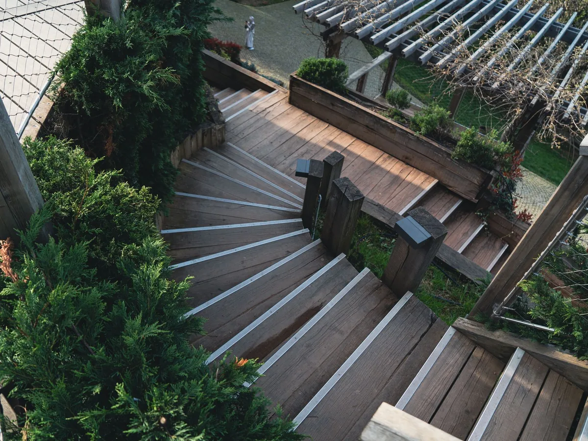 Wooden steps lead through a landscaped park.