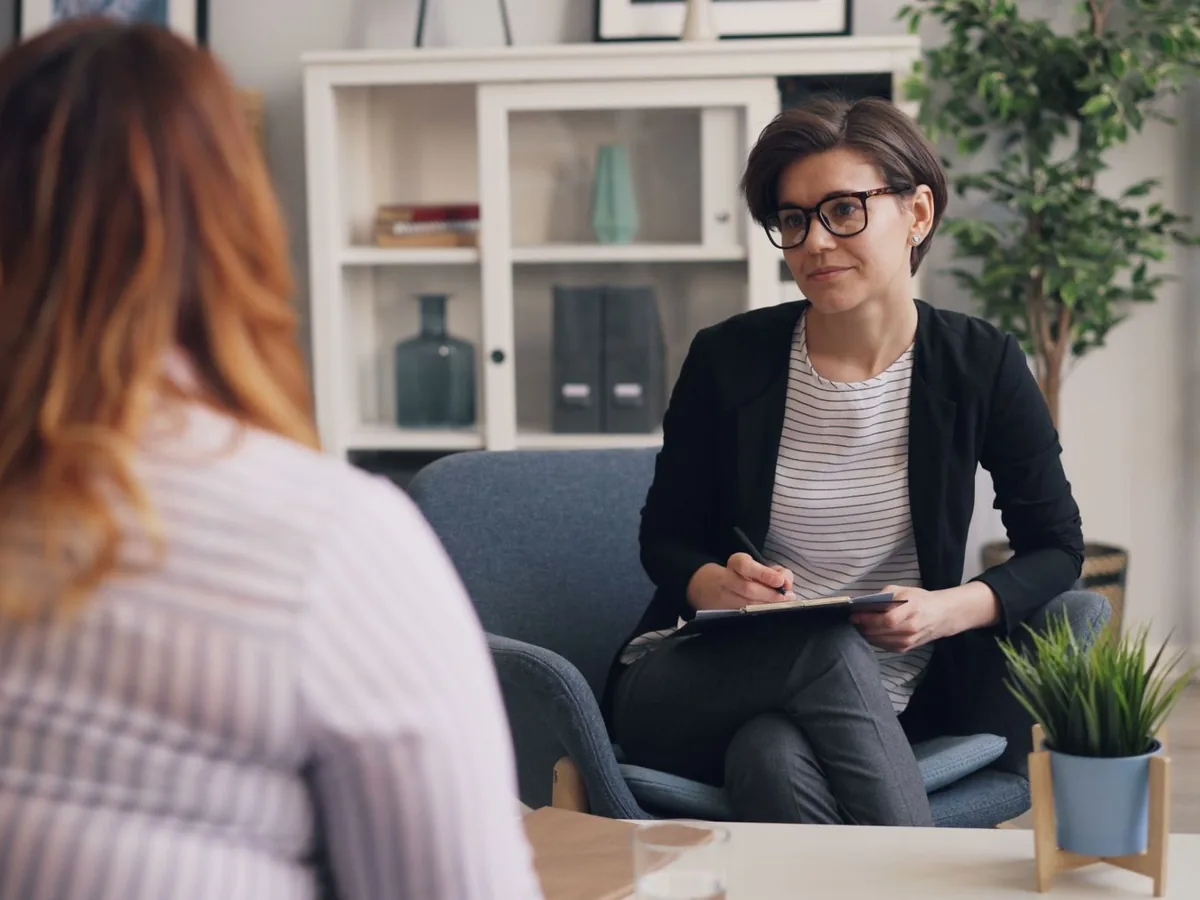 Two women talk together during a counselling session.