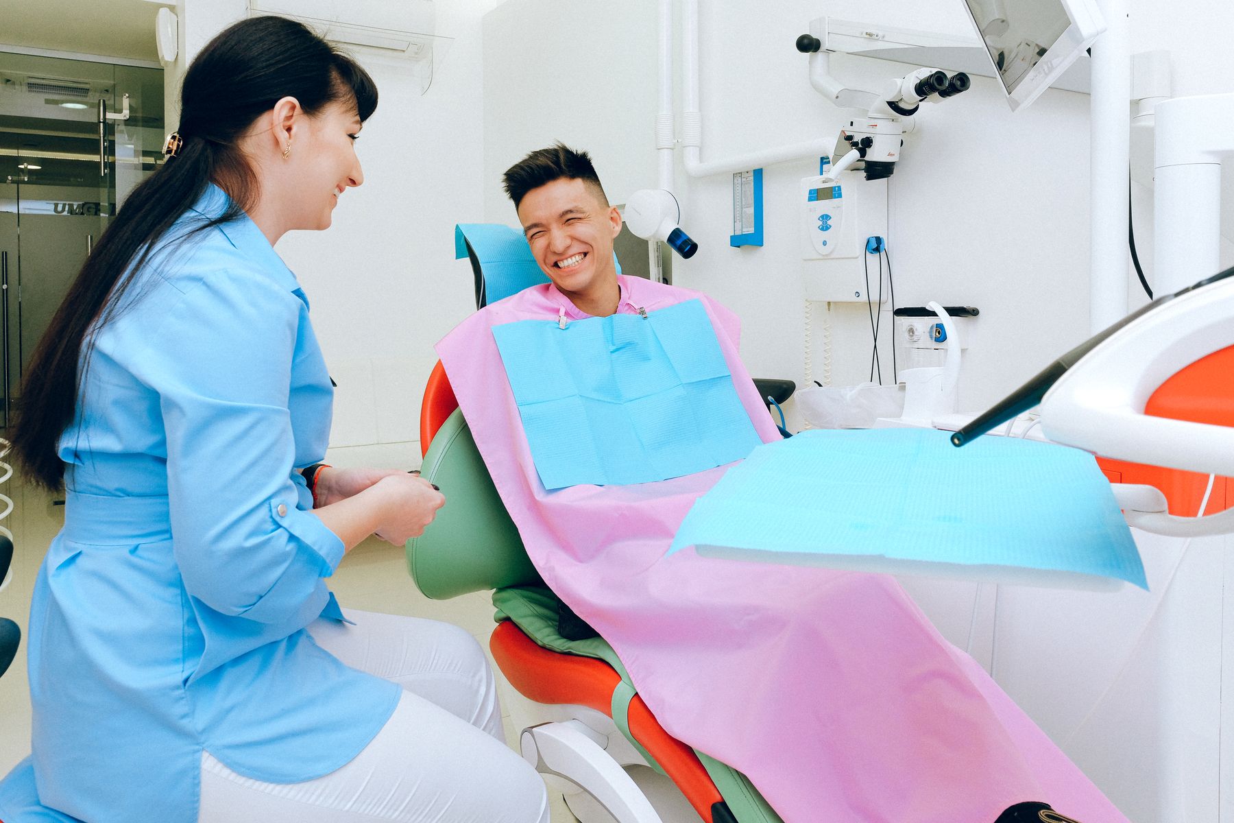 Dentist and patient sharing a relaxed conversation during a visit